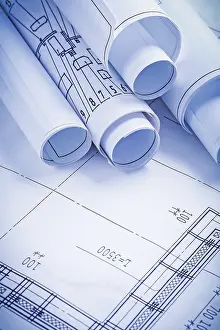 Rolled Up Documents Drucke: Close up view stack of white construction blueprints