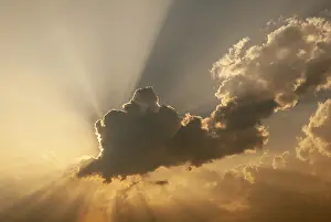 Deserted Landscape France Drucke: Cloud in front of the sun showing rays of light