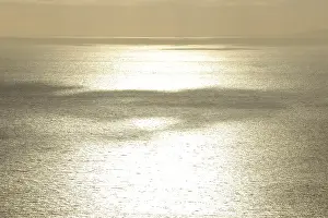 Atmospheric Evening Mood Drucke: Clouds casting shadows over the sea