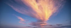 Overcast Evening Atmosphere Drucke: Clouds glow orange in the evening light