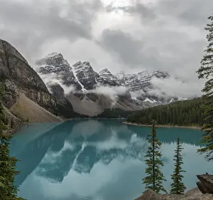 Mountainous Landscape Conservation Drucke: Clouds hanging between the mountain peaks
