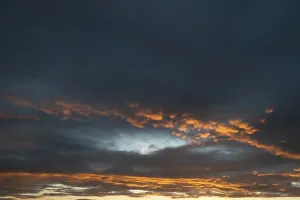 Deserted Landscape France Drucke: Clouds, illuminated orange during sundown