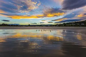 Cloudy Evening Sky Drucke: Clouds are reflected in the gentle ripples of the surf