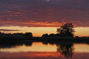 Cloudy Atmospheric Light Scene Drucke: Clouds in the sunset with reflection on the river Trebel