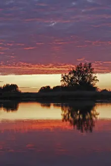 German Nature Park Scenery Drucke: Clouds in the sunset with reflection on the river Trebel