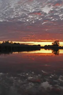 Northern Germany Nature Reserve Scenery Drucke: Clouds in the sunset with reflection on the river Trebel