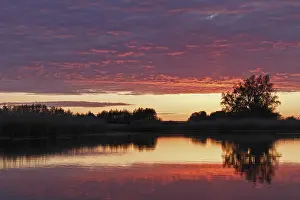 Northern Germany Nature Reserve Scenery Drucke: Clouds in the sunset with reflection on the river Trebel