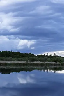 Northern German Nature Scenery Drucke: Cloudy sky over a quiet river with trees in the background
