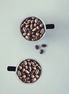 White Background Concept Drucke: Coffee beans falling into a cup