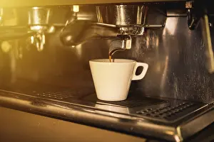 Coffee Machine Detail Drucke: Coffee machine putting a decaf in a white cup