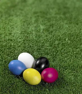 Colourful Easter Tradition Drucke: Some colored Easter eggs in green artificial grass background