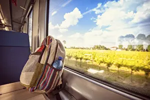 Deserted Train Station Scene Drucke: Colorful backpack on the train near the window