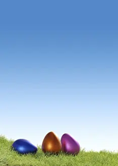 Easter Eggs Drucke: Three colorful Easter eggs on a grass background using as seasonal backdrop