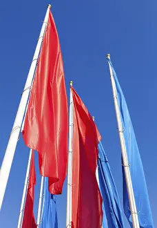 Blue Sky Background Drucke: Colorful flags on blue sky background