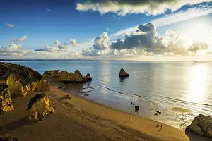 Cloudy Morning Atmosphere Drucke: Coloured cliffs and sunrise at the beach