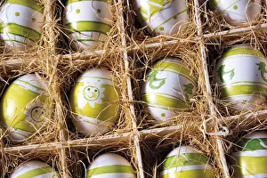 Christian Easter Traditions Drucke: Coloured Easter eggs in a box with straw