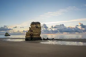 Steep Cliff Photography Drucke: Colourful cliffs and sunrise on the beach