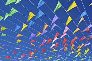 Costa Blanca Spain Drucke: Colourful flags against a blue sky