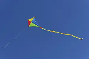 Deserted Seaside Resort Drucke: Colourful kite in flight against a cloudless sky