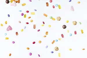 Colourful Dessert Photography Drucke: Colourful sweets fall against a white background