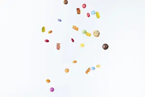Colourful Sweets Drucke: Colourful sweets fall against a white background