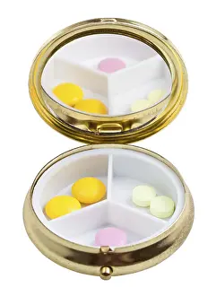 Healthcare System Drucke: Compact pill box with mirror and multiple tablets against white background