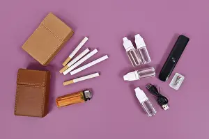 Transporting Goods By Sea Drucke: Comparison between electronic and real cigarette with tools on violet background