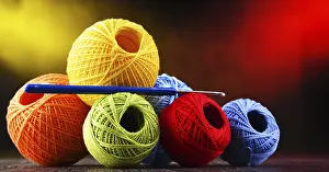 Handicraft Supplies Drucke: Composition with assortment of different colored yarns and hook for crocheting