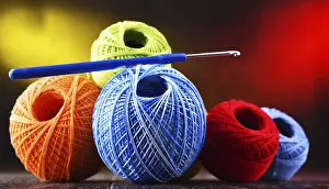 Handicraft Supplies Drucke: Composition with assortment of different colored yarns and hook for crocheting