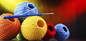 Handicraft Supplies Drucke: Composition with assortment of different colored yarns and hook for crocheting