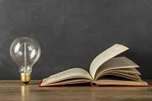 Learning Concept Image Drucke: Composition with book light bulb