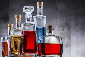 Distilled Spirits Showcase Drucke: Composition with carafe and bottles of assorted alcoholic beverages