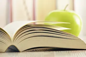 Deserted Library Scene Drucke: Composition with green apple and books on the table