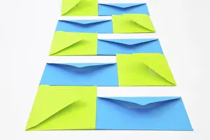 Empty Office Desk Drucke: Composition with green and blue envelopes on the white table