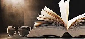 Deserted Library Scene Drucke: Composition with open book and glasses on the table