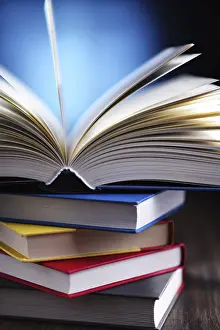 Educational Institution Art Print Drucke: A composition with an open book lying on a stack of other books
