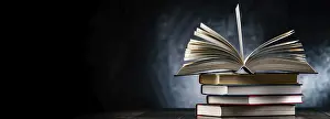 University College Study Space Drucke: A composition with an open book lying on a stack of other books