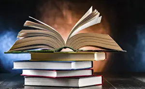 Educational Institution Art Print Drucke: A composition with an open book lying on a stack of other books