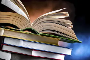 Open Book Drucke: A composition with an open book lying on a stack of other books