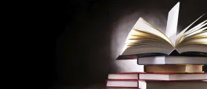 Deserted Library Scene Drucke: A composition with an open book lying on a stack of other books