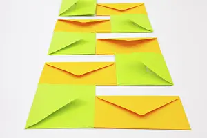 Communication Symbols Drucke: Composition with yellow and green envelopes on the white table