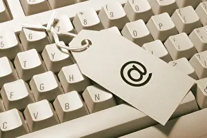 Computer Accessory Photo Drucke: Computer keyboard and commerical @ sign tag