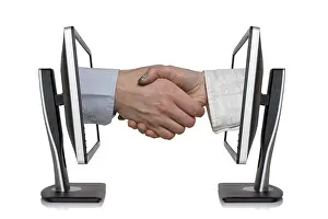 Wireless Communication Drucke: Two computer monitors and hands in handshaking