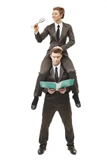 Business Couple Drucke: Concept of office life. Two acrobats posing at camera