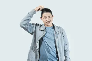 Frustrated Teenager Drucke: Confused guy scratching head isolated