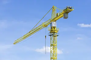 Construction Crane Drucke: Construction crane in front of a blue sky, clouds