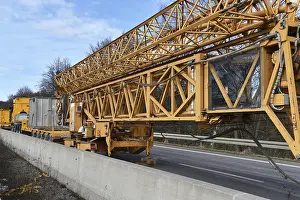 Construction Crane Drucke: Construction crane and low loader at a building site