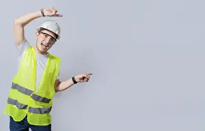 Architectural Style Drucke: Construction engineer with vest pointing at an advertisement