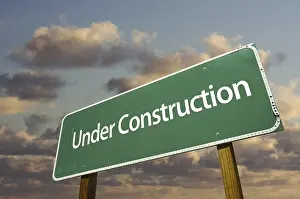 Cloudy Sky Background Drucke: Under construction green road sign over dramatic clouds and sky