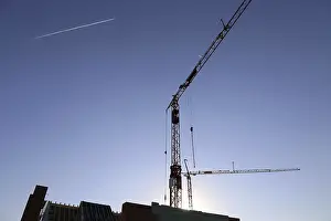 Construction Industry Symbol Drucke: Construction site with cranes at nightfall